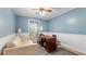 Bedroom features blue walls, white trim, and a wooden desk, great for a home office at 4771 Pinefield Nw Dr, Acworth, GA 30102