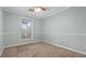 This bedroom features bright white trim, light green walls, tan carpet, and a ceiling fan at 4771 Pinefield Nw Dr, Acworth, GA 30102