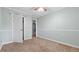This bedroom features light green walls, tan carpet, bright white trim and a ceiling fan at 4771 Pinefield Nw Dr, Acworth, GA 30102