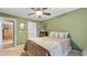Cozy bedroom with a large bed, ceiling fan, and wood floors for a comfy feel at 4771 Pinefield Nw Dr, Acworth, GA 30102