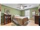 Cozy bedroom with a large bed, ceiling fan, and wood floors for a comfy feel at 4771 Pinefield Nw Dr, Acworth, GA 30102