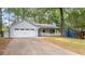 Charming home with light gray siding, a welcoming front porch, and a two-car garage at 4771 Pinefield Nw Dr, Acworth, GA 30102