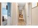 Hallway with neutral walls and flooring leads to a living area with striped chair at 4771 Pinefield Nw Dr, Acworth, GA 30102