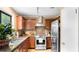 Well-equipped kitchen with stainless steel appliances, granite countertops, and warm wood cabinetry at 4771 Pinefield Nw Dr, Acworth, GA 30102