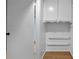 This small laundry room has white cabinets, shelves, and linoleum tile at 4771 Pinefield Nw Dr, Acworth, GA 30102