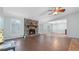 Spacious living room with stone fireplace, ceiling fan, and lots of natural light at 4771 Pinefield Nw Dr, Acworth, GA 30102