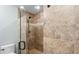Tiled walk-in shower featuring glass door and stone seat at 4771 Pinefield Nw Dr, Acworth, GA 30102