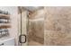 Elegant tiled shower with glass door and pebble floor, offering a spa-like experience at 4771 Pinefield Nw Dr, Acworth, GA 30102