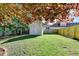 Backyard featuring a storage shed, green lawn, mature trees, and a wooden fence for outdoor activities at 1550 Misty Valley Dr, Lawrenceville, GA 30045