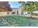 Spacious backyard with green lawn, mature trees, and a view of the house, perfect for outdoor activities at 1550 Misty Valley Dr, Lawrenceville, GA 30045