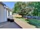A backyard patio, BBQ, and views of the lawn, trees, and fenced yard offer a perfect outdoor area at 1550 Misty Valley Dr, Lawrenceville, GA 30045