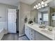 Bright bathroom featuring double sinks, modern fixtures, and a bathtub and shower combo at 1550 Misty Valley Dr, Lawrenceville, GA 30045