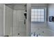 Bright bathroom featuring a bathtub and shower combo, with tiled walls and modern fixtures at 1550 Misty Valley Dr, Lawrenceville, GA 30045