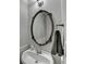 Well-lit half bathroom featuring a decorative mirror, a vessel sink, and neutral tones at 1550 Misty Valley Dr, Lawrenceville, GA 30045