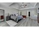 Large main bedroom with neutral colored walls and furnishings plus tray ceiling at 1550 Misty Valley Dr, Lawrenceville, GA 30045