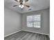 Comfortable bedroom with a ceiling fan, a window, and wood-look floors at 1550 Misty Valley Dr, Lawrenceville, GA 30045