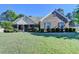Charming single-story brick home with manicured lawn and mature trees at 1550 Misty Valley Dr, Lawrenceville, GA 30045