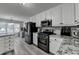 Spacious kitchen with stainless steel appliances, white cabinets and countertops at 1550 Misty Valley Dr, Lawrenceville, GA 30045