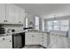 Open concept kitchen with stainless steel dishwasher and eat-in dining area at 1550 Misty Valley Dr, Lawrenceville, GA 30045