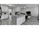 Kitchen island with stainless steel sink and open view into living room and fireplace at 1550 Misty Valley Dr, Lawrenceville, GA 30045
