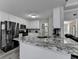 Well-lit kitchen featuring stainless steel appliances, granite countertops, and white cabinetry at 1550 Misty Valley Dr, Lawrenceville, GA 30045