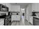 Kitchen with stainless steel appliances and white cabinets, with a view into the dining room at 1550 Misty Valley Dr, Lawrenceville, GA 30045