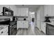 Kitchen with stainless steel appliances and white cabinets with view into dining room at 1550 Misty Valley Dr, Lawrenceville, GA 30045