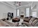Comfortable living room with a fireplace, large windows, and plush seating at 1550 Misty Valley Dr, Lawrenceville, GA 30045