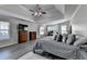 Spacious main bedroom featuring a ceiling fan, ensuite office space, and wood-look floors at 1550 Misty Valley Dr, Lawrenceville, GA 30045