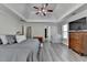 Spacious main bedroom featuring a ceiling fan, wood-look floors and calming gray walls at 1550 Misty Valley Dr, Lawrenceville, GA 30045