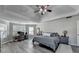 Spacious main bedroom featuring a ceiling fan, ensuite office space, and wood-look floors at 1550 Misty Valley Dr, Lawrenceville, GA 30045