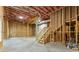 Unfinished basement with exposed framing, stairs, and utilities, ready for customization at 216 Creek View Pl, Canton, GA 30114