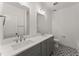 Elegant bathroom featuring dual sinks, stylish mirrors, and patterned tile flooring at 216 Creek View Pl, Canton, GA 30114