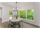 Elegant dining room featuring a modern chandelier and windows overlooking the outdoor scenery at 216 Creek View Pl, Canton, GA 30114