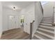 Bright foyer with hardwood floors, white trim, and staircase leading to the upper level at 216 Creek View Pl, Canton, GA 30114