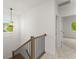 Bright hallway with carpet, modern light fixture, and a view of the landing at 216 Creek View Pl, Canton, GA 30114