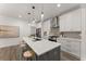 Modern kitchen boasts stainless steel appliances, a large island, and stylish pendant lighting at 216 Creek View Pl, Canton, GA 30114