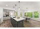 Open-concept kitchen with a large island, stainless appliances, and seamless flow to the living area at 216 Creek View Pl, Canton, GA 30114