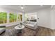 Open-concept living room with hardwood floors, large windows, and seamless flow to the kitchen at 216 Creek View Pl, Canton, GA 30114