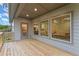 Spacious porch with gray siding and wooden deck, offering great lighting from the interior at 216 Creek View Pl, Canton, GA 30114