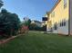 Spacious backyard features a well-manicured lawn, wooden garden bed, and basketball hoop for outdoor enjoyment at 3670 Kissell Dr, Cumming, GA 30041