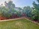 Large backyard with trees along fence line and garden at 3670 Kissell Dr, Cumming, GA 30041
