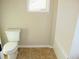 Clean bathroom featuring tiled floors, a white toilet, and a bathtub at 3670 Kissell Dr, Cumming, GA 30041