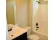 Standard bathroom with tub and shower, single sink vanity and matching toilet at 3670 Kissell Dr, Cumming, GA 30041