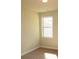 Small bedroom with a window and carpeted floor at 3670 Kissell Dr, Cumming, GA 30041