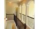 Upstairs hallway with arches, dark wood railings, and neutral paint at 3670 Kissell Dr, Cumming, GA 30041