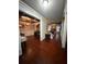 Open-concept living space with hardwood floors, coffered ceilings, and elegant furnishings at 3670 Kissell Dr, Cumming, GA 30041
