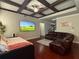 Comfortable living room with coffered ceiling, large television, and plush leather seating at 3670 Kissell Dr, Cumming, GA 30041