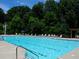 Sparkling community pool with lounge chairs, surrounded by lush greenery for a relaxing atmosphere at 3670 Kissell Dr, Cumming, GA 30041