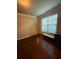 Room with hardwood floors, bright window, and neutral wall color at 3670 Kissell Dr, Cumming, GA 30041